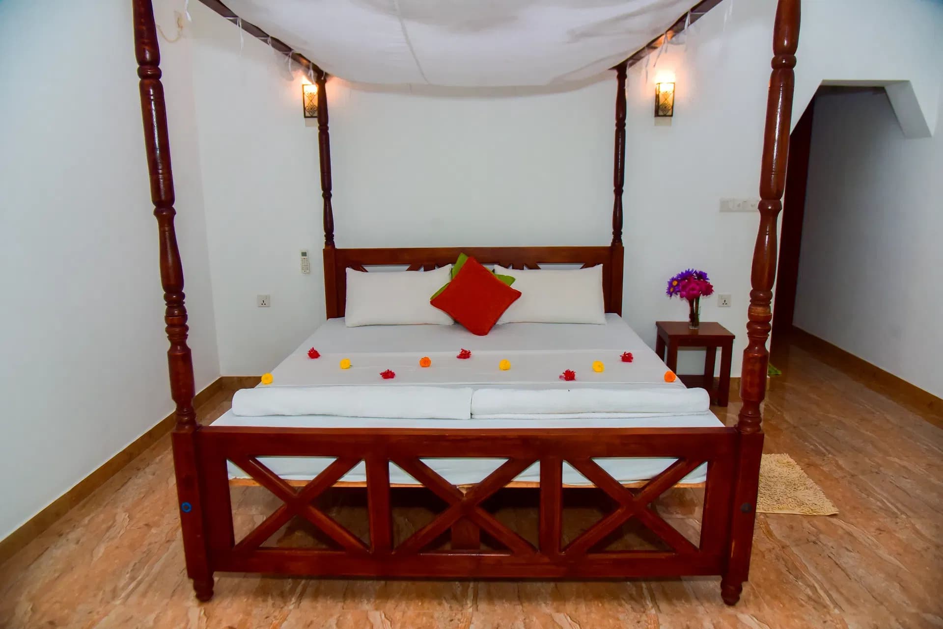 Standard room with cozy bed and wall lamps